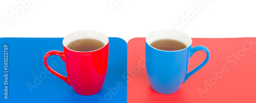 Tea cups in red and blue on red and blue background. Free space for text. Wide photo. Valentines day concept.