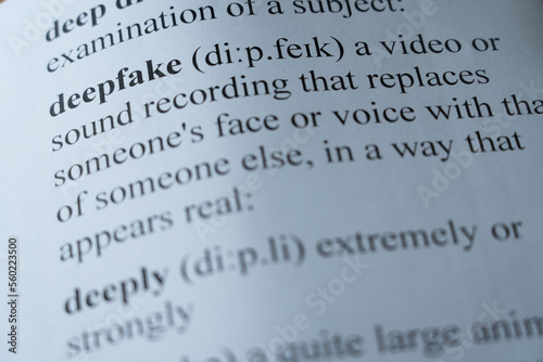 A mock up of a dictionary page with the word deepfake with selective focussing photo