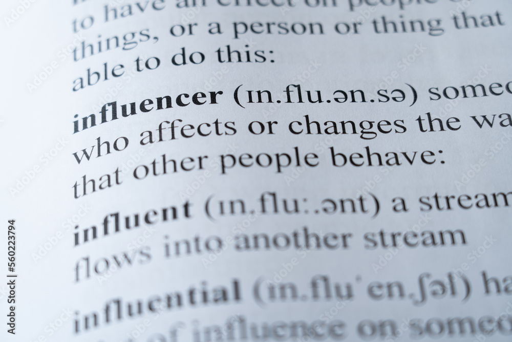 A mock up of a dictionary page with the word influencer with selective focussing A mock up of a dictionary page with the word influencer with selective focussing