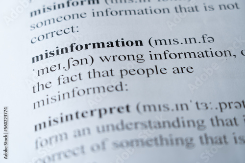 A mock up of a dictionary page with the word misinformation with selective focussing photo