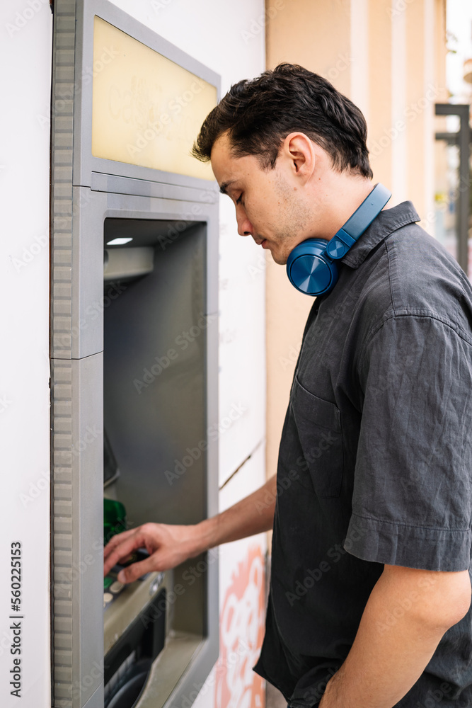 Fototapeta premium man withdraws money from ATM