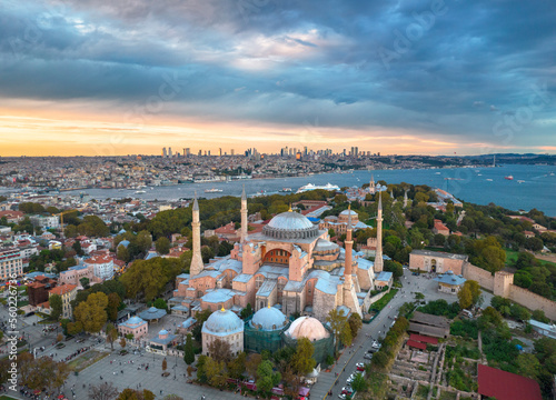 Photography Mosque at sunset with skyscrapers looming in the background