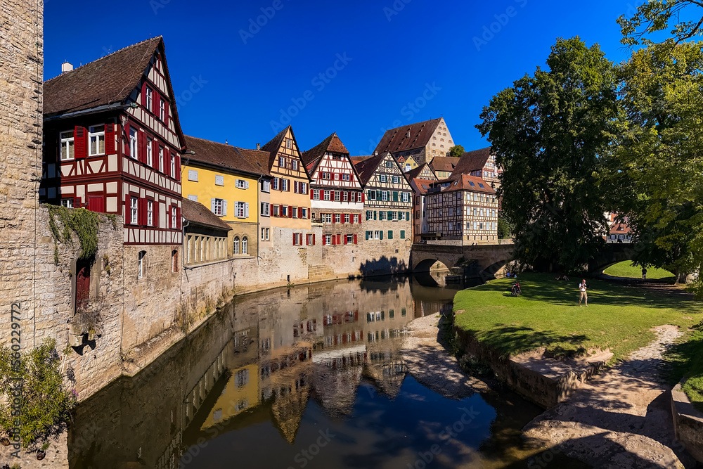 Idyllic panorama in a German old town on a river with city wall and half-timbered houses