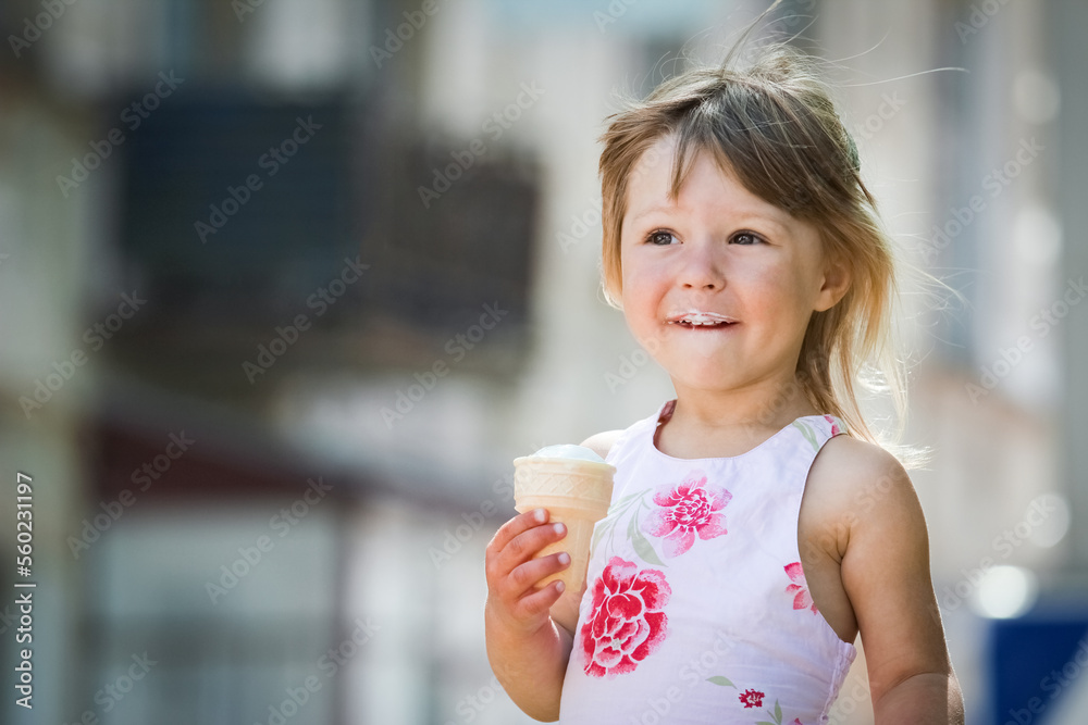 Happy child eating ice cream on the nature park in the city Happy child eating ice cream on the nature park in the city