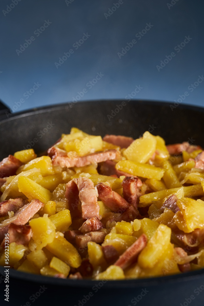 Potatoes and ham in a wok