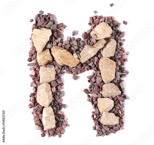 Stone in shape letter M, rock isolated on white, clipping path photo