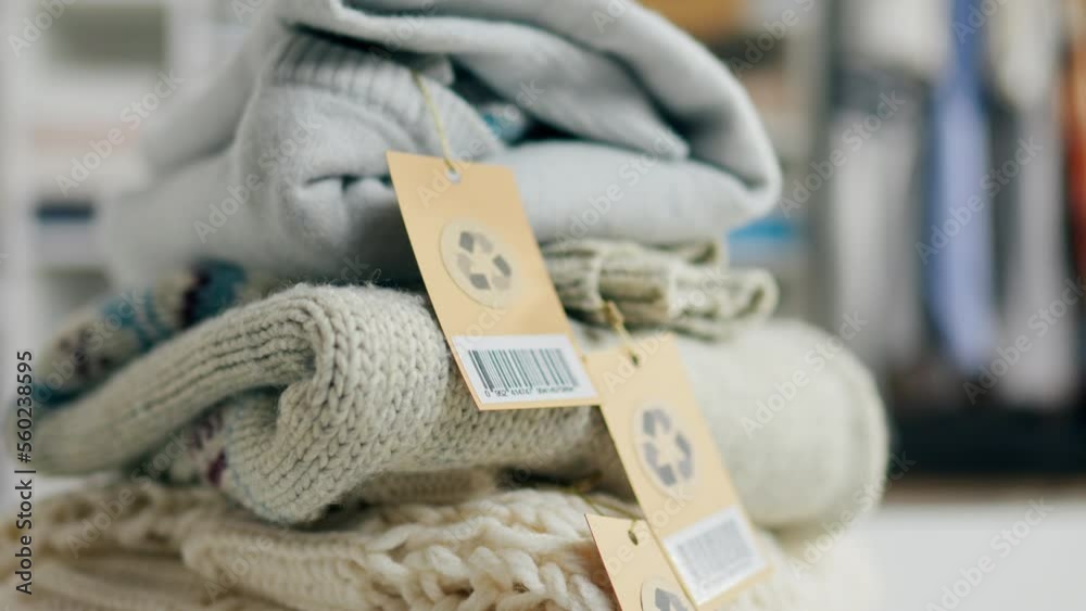 Video Stock Stack of clothes with tags and recycle sign, recycle sign