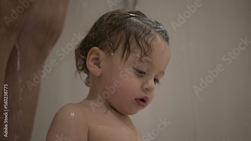 Cute baby toddler boy inside shower bath