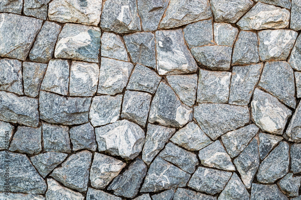 Fototapeta premium Wall of gray cracked stones. Pattern. Advertising space. Design element. Background. Horizontal.
