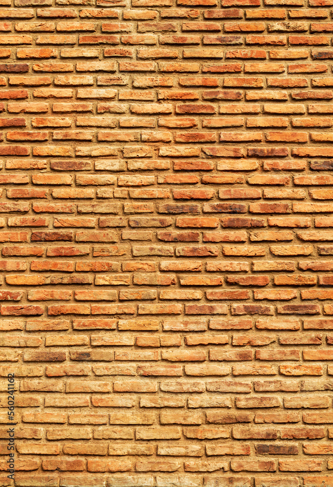 Wall of brown, red and orange bricks. Pattern. Advertising space. Design element. Background. Vertical. Wall of brown, red and orange bricks. Pattern. Advertising space. Design element. Background. Vertical.