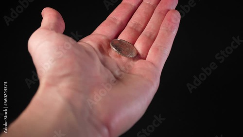 The man stretches out and opens his hand with a 4k coin. Donation assistance.