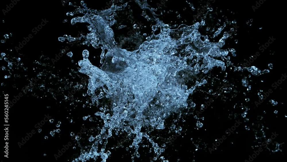 Super slow motion of splashing water crown shape on black background ...