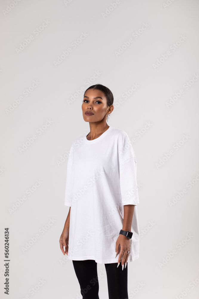 African american woman in oversized white t-shirt. Mock-up. African american woman in oversized white t-shirt. Mock-up.