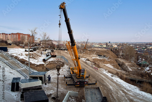 Mobile crane on the construction of a road junction. Construction equipment.
