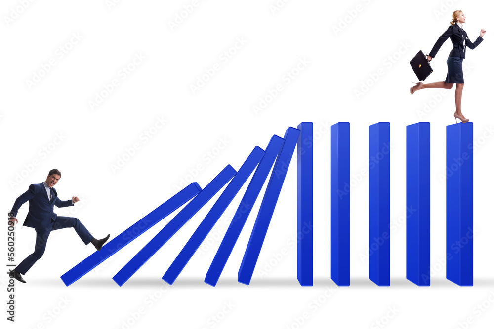 Businessman in domino effect concept Businessman in domino effect concept