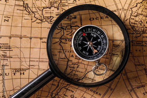 Compass and magnifier on wo...
