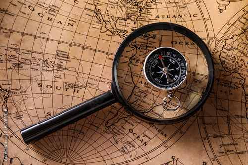 Compass and magnifier on wo...
