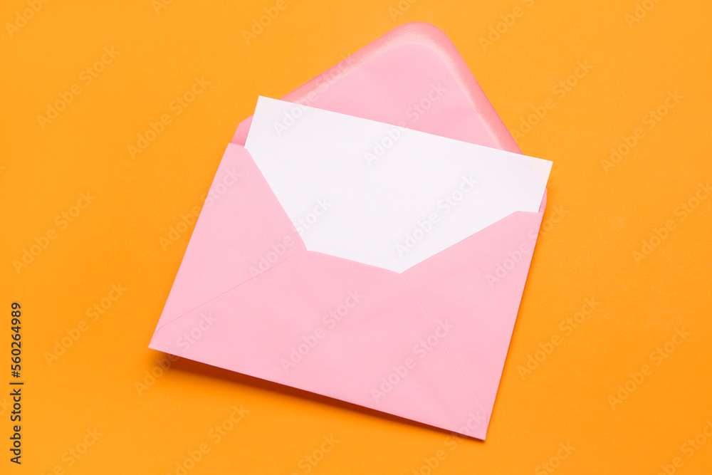 Pink envelope with card on color background Pink envelope with card on color background