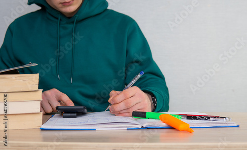 close-up of a college student solving math problems. Learning integrals. Exam preparation