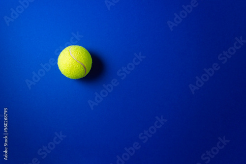 Tennis ball for trigger points on dark blue background. Equipment for myofascial release and self massage. Reflexology therapy concept. Selective focus, copy space © ClareM