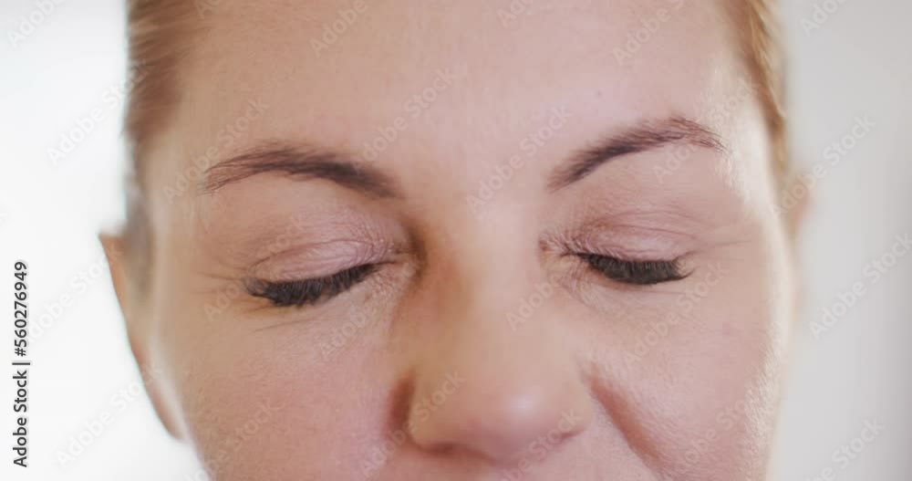 Video close up portrait of the closing and smiling eyes of caucasian female doctor in hospital Video close up portrait of the closing and smiling eyes of caucasian female doctor in hospital