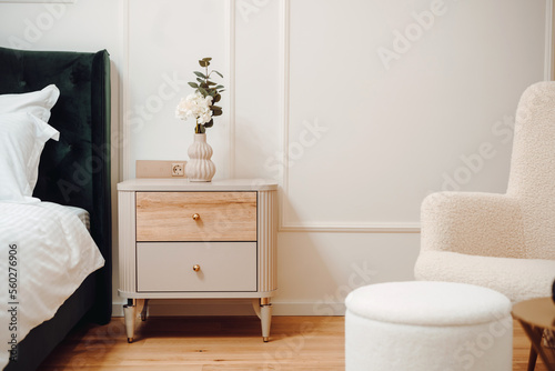 Close up of beautiful nightstand in elegant and comfortable modern bedroom. Interior design details