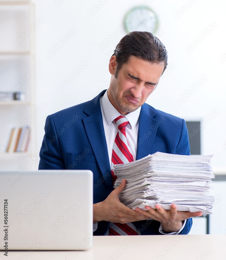 Young male businessman sitting in the office Young male businessman sitting in the office