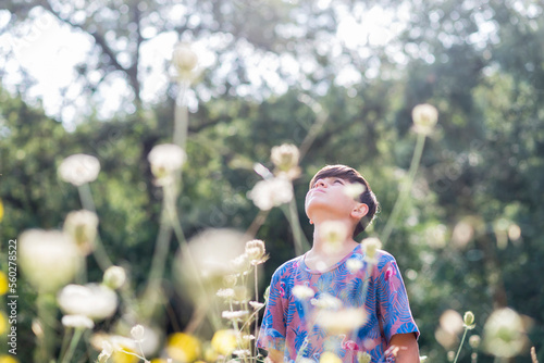 Young teen looking up  deep in thoughts in a natural environmet photo