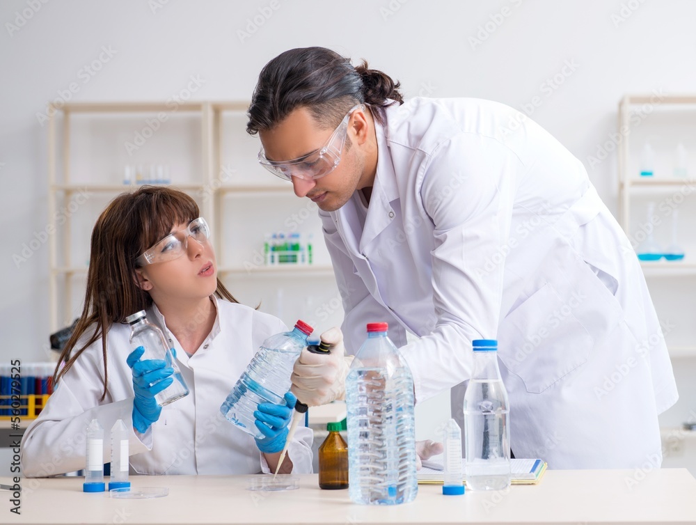 Two chemists working in the lab Two chemists working in the lab