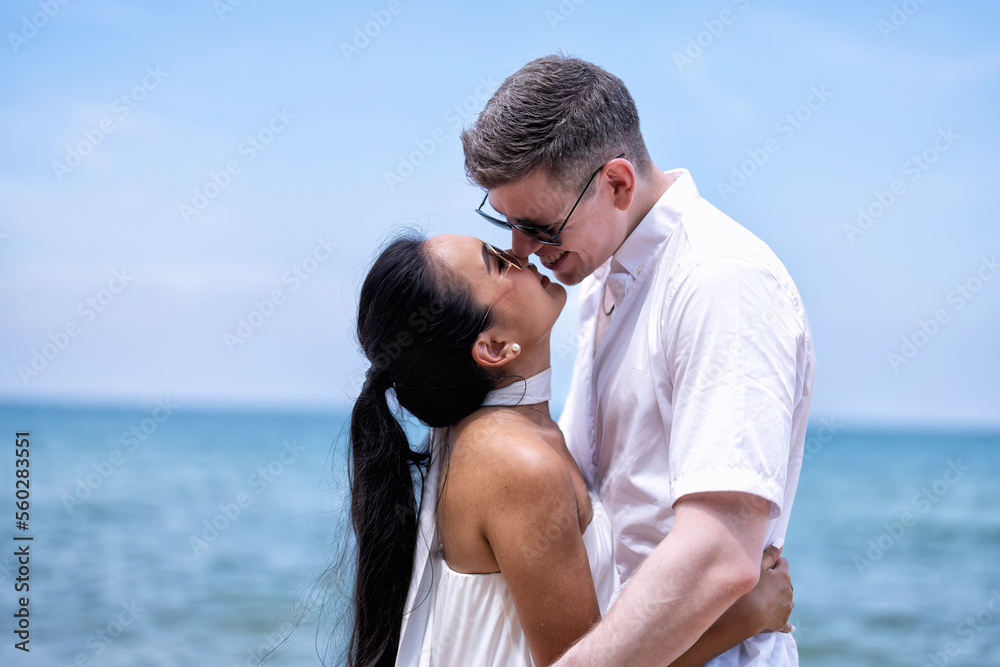 Love couple on holiday happy playing running along the beach and sweet kiss on love emotion Love couple on holiday happy playing running along the beach and sweet kiss on love emotion