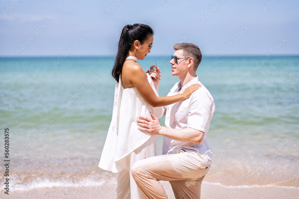 Love couple on holiday happy playing running along the beach and wedding proposed on love emotion Love couple on holiday happy playing running along the beach and wedding proposed on love emotion