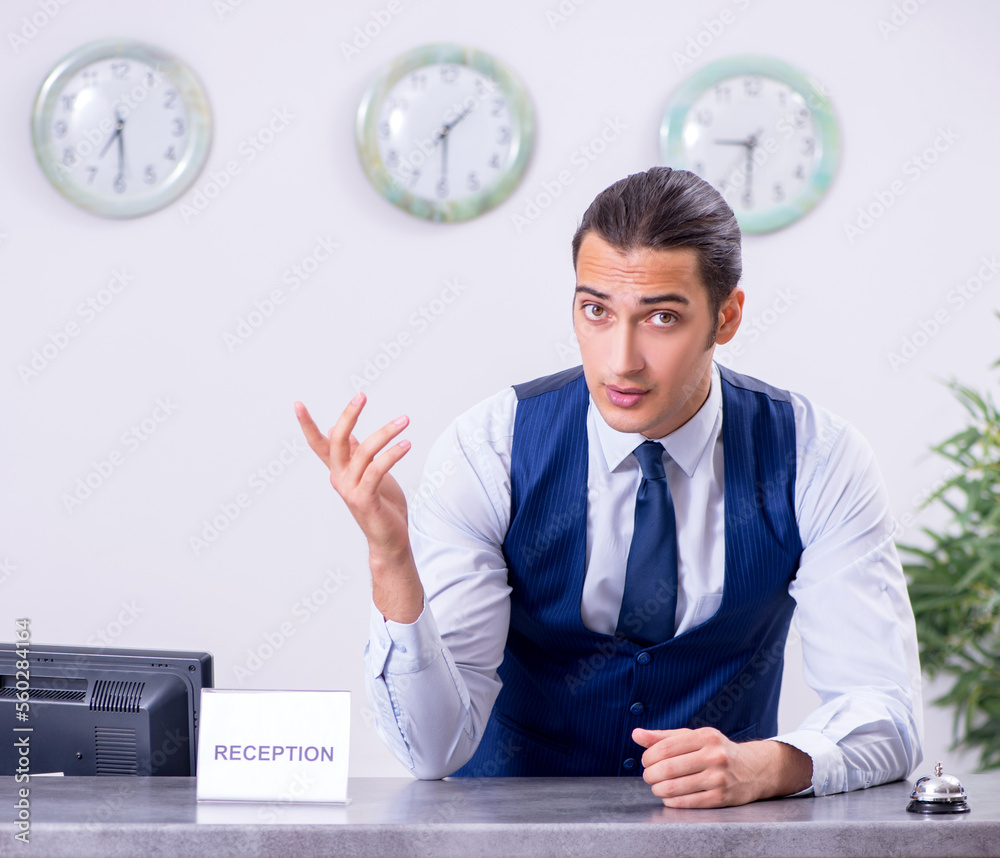 Young man receptionist at the hotel counter Young man receptionist at the hotel counter