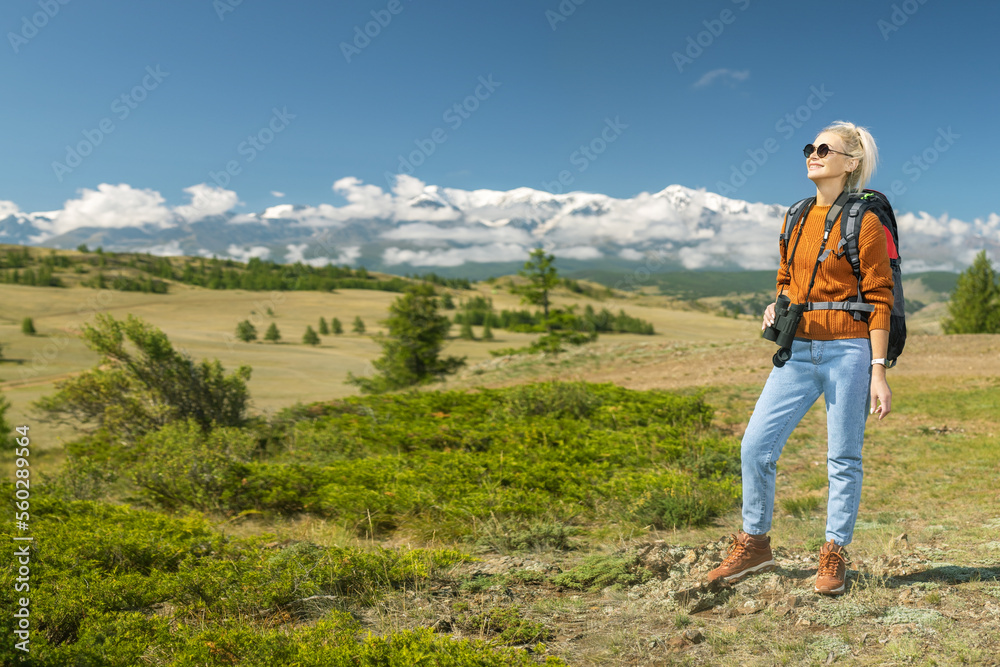 happy woman hiker enjoying outdoor activity. mature woman hiking, binocular and vision in mountains with backpack,