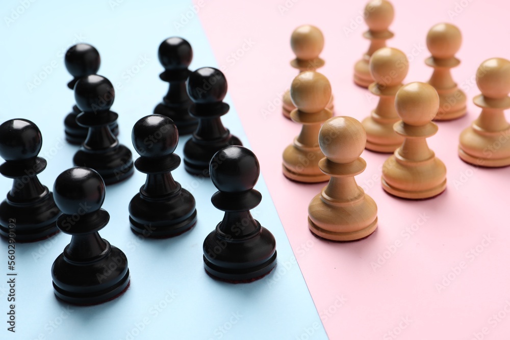 Chess pieces on color background, closeup. Gender equality Chess pieces on color background, closeup. Gender equality