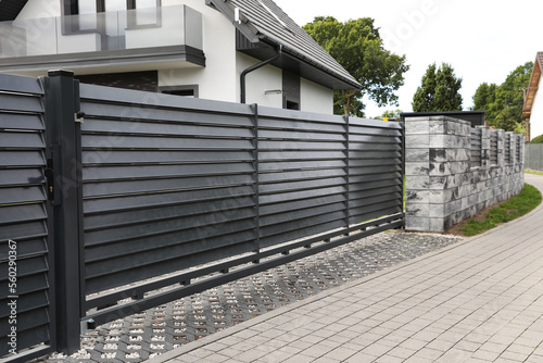 Fényképezés Metal gates near marble columns and house outdoors
