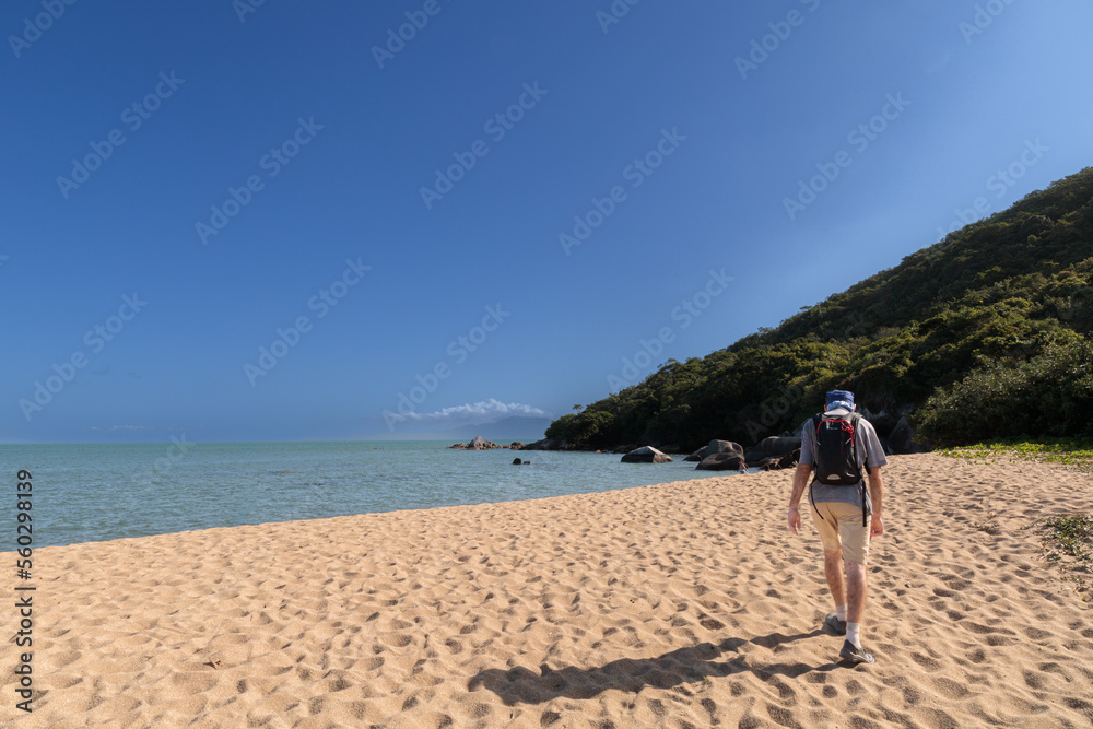 person walking on the beach