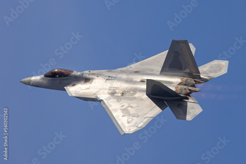 Close side view of a F-22 Raptor in beautiful light ,  with afterburners on