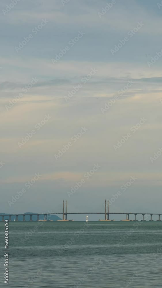 vertical Timelapse cloudy sunset ray over Penang Bridge over ocean connecting penang island with sunset vanilla sky time,famous landmark in malaysia vertical Timelapse cloudy sunset ray over Penang Bridge over ocean connecting penang island with sunset vanilla sky time,famous landmark in malaysia