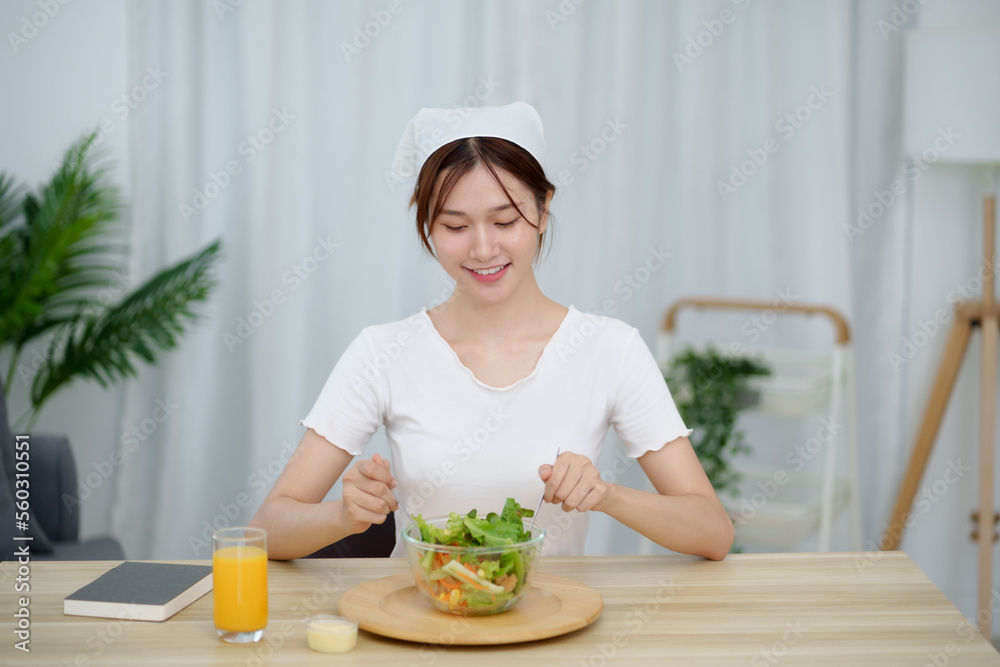 Portrait of happy playful asian girl eating fresh salad in diet concept Portrait of happy playful asian girl eating fresh salad in diet concept