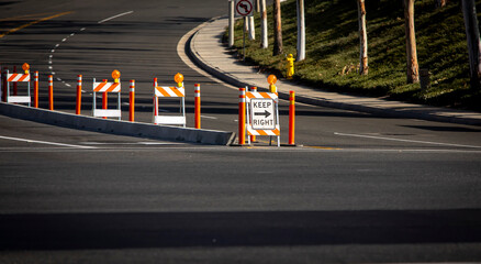 Traffic sign and cones around construction of a cement street island