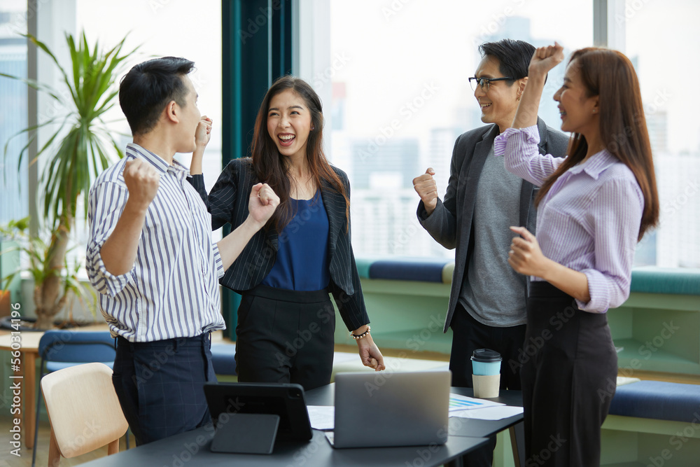 businesspeople raise arms up and celebrating success at work in the office businesspeople raise arms up and celebrating success at work in the office