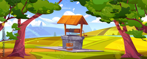Old stone well with drinking water and wooden bucket  agricultural fields on green hills near forest trees. Vector cartoon illustration of rural summer landscape under blue sunny sky and white clouds