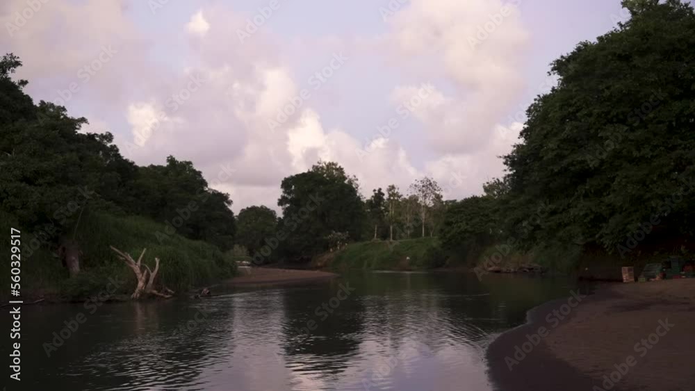 Tarcoles riverbed in Costa Rica with pastel-colored clouds behind, Wide locked shot Tarcoles riverbed in Costa Rica with pastel-colored clouds behind, Wide locked shot