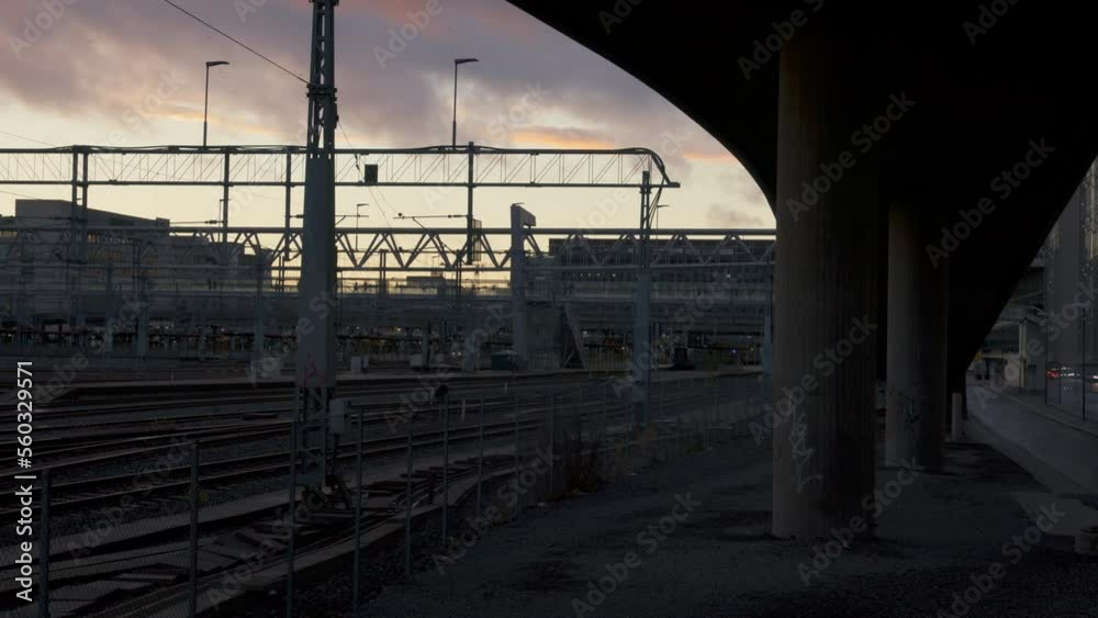 Oslo Central Station in the sunset. Pedestrians crossing a footbridge in the background. Oslo Central Station in the sunset. Pedestrians crossing a footbridge in the background.