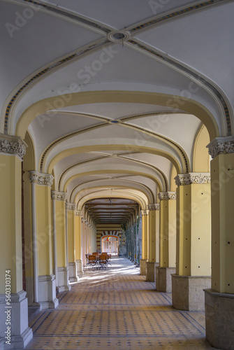 Corridor between the support pillars of an old building. Architectural elements.