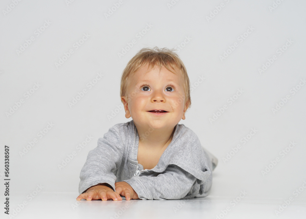 Little, happy and smiling cute baby in the studio. Portrait of a one year old baby. The concept of happiness. Little, happy and smiling cute baby in the studio. Portrait of a one year old baby. The concept of happiness.