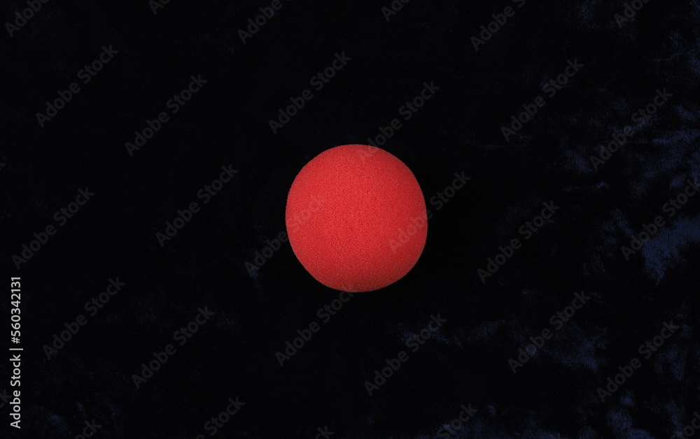 Red Nose Day, red nose of a clown on a black background Red Nose Day, red nose of a clown on a black background