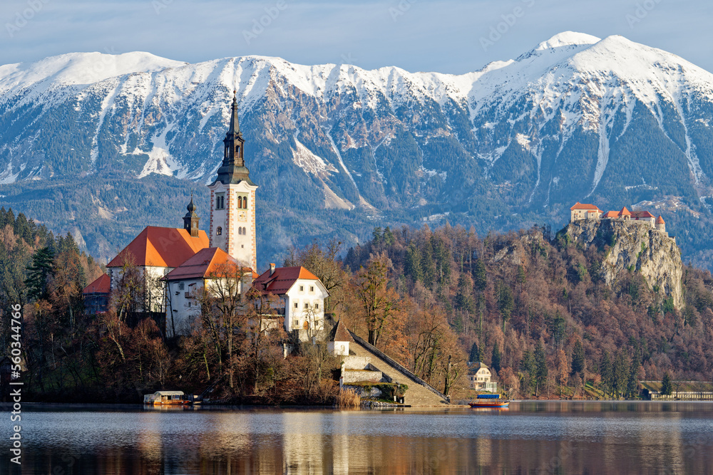 Sunrise winter scenery of magical Lake Bled in Slovenia. A winter tale for romantic experiences. Mountains with snow in the background. Church of the Mother of God on a little Island in the lake.
