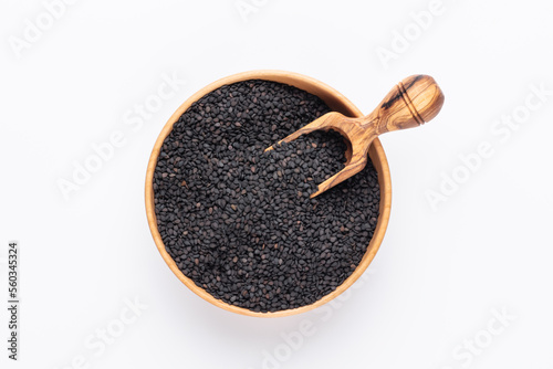 Bio natural black sesame seeds on wooden bowl.