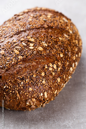 Gold rustic crusty loaves of bread and buns on wooden background. Still life captured from above top view, flat lay.